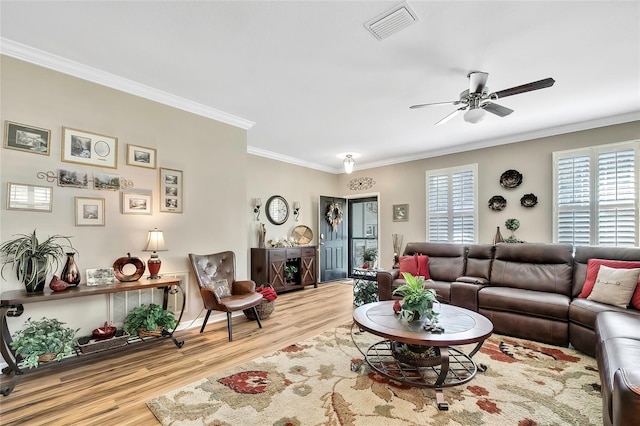 living room with crown molding, light hardwood / wood-style flooring, and ceiling fan