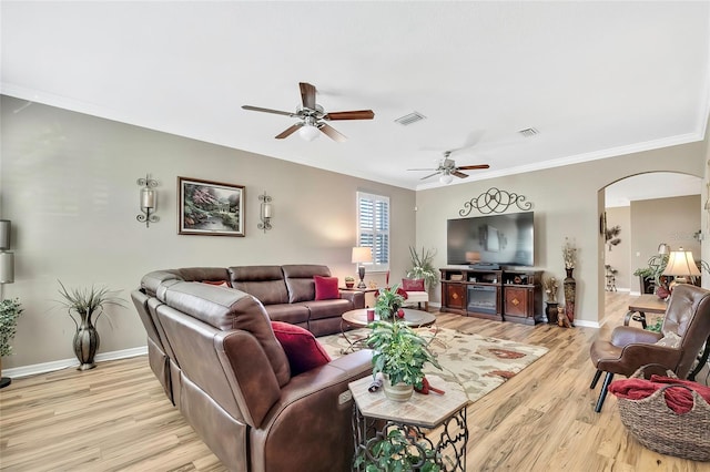 living room with crown molding, ceiling fan, and light wood-type flooring