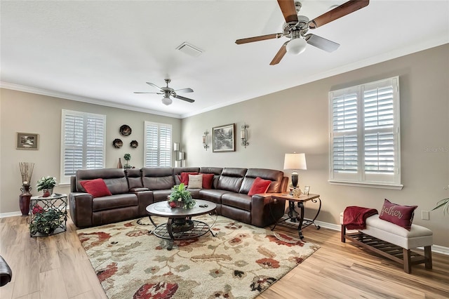 living room with ceiling fan, ornamental molding, and light hardwood / wood-style flooring