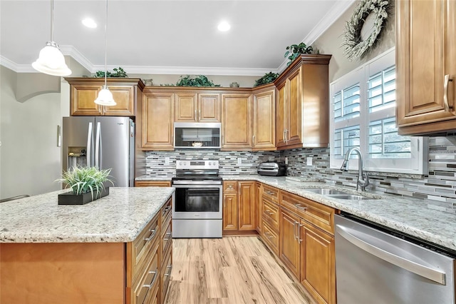 kitchen featuring crown molding, sink, stainless steel appliances, and hanging light fixtures