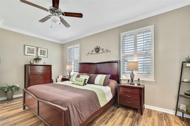 bedroom with ceiling fan, light wood-type flooring, and ornamental molding