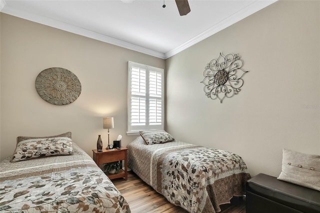 bedroom featuring ceiling fan, crown molding, and light wood-type flooring