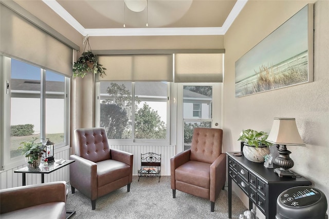 living area with carpet flooring and ornamental molding