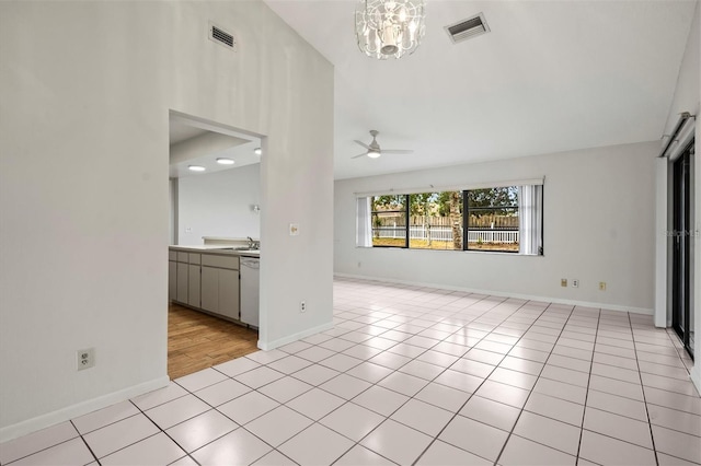 unfurnished living room with light tile patterned floors, ceiling fan with notable chandelier, and sink