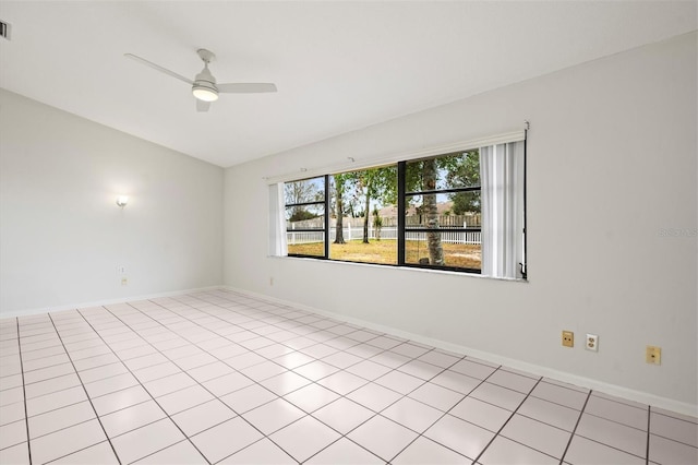 spare room with ceiling fan and light tile patterned flooring