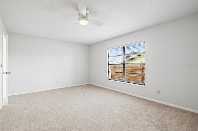 unfurnished room with light colored carpet, a textured ceiling, and ceiling fan