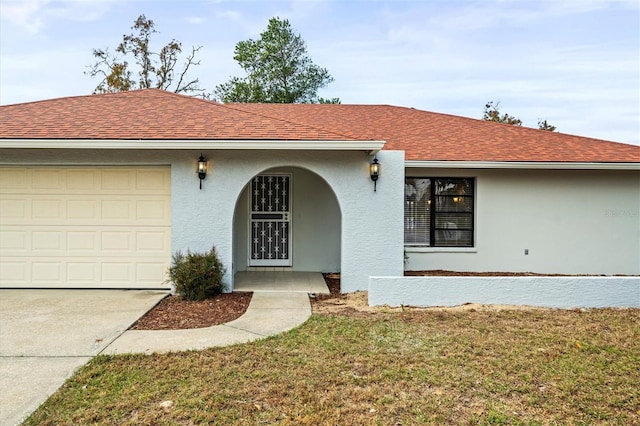 ranch-style house with a garage and a front yard