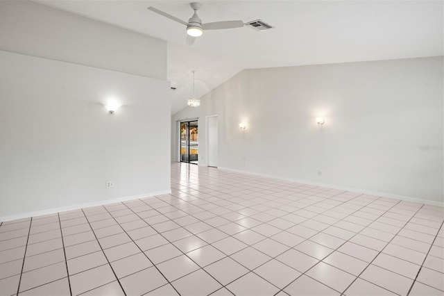 spare room with ceiling fan with notable chandelier, light tile patterned floors, and lofted ceiling