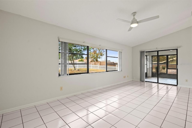 tiled empty room featuring vaulted ceiling and ceiling fan