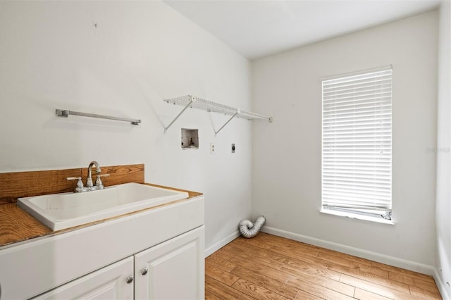 washroom featuring sink, cabinets, washer hookup, electric dryer hookup, and light wood-type flooring