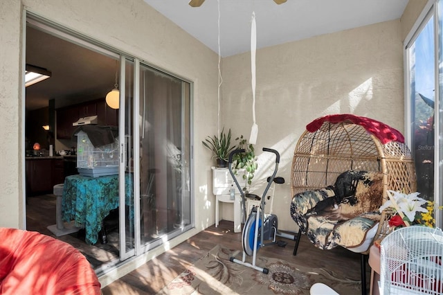 sunroom / solarium featuring ceiling fan