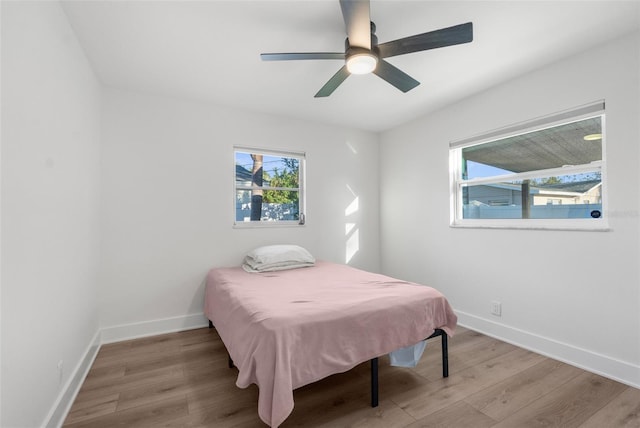 bedroom with ceiling fan and light wood-type flooring