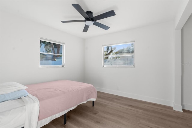 bedroom featuring hardwood / wood-style floors and ceiling fan