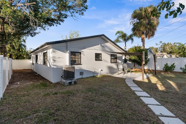 back of property featuring a yard, central AC, and a patio area