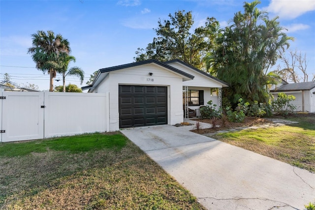 single story home featuring a garage and a front lawn