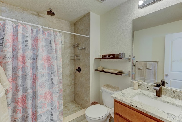 bathroom with vanity, curtained shower, toilet, and a textured ceiling