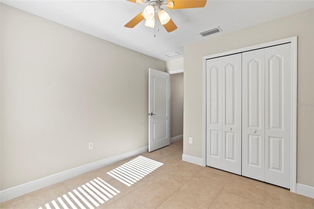 unfurnished bedroom featuring ceiling fan, a closet, and light tile patterned flooring