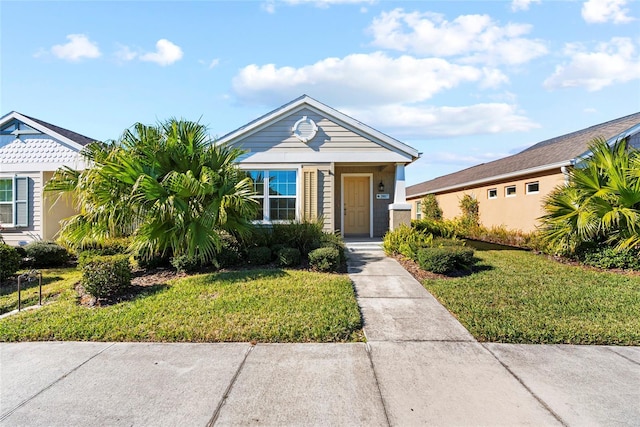 bungalow-style home with a front yard