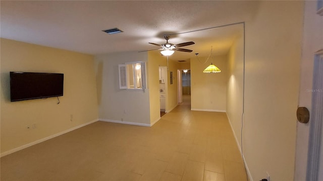 empty room featuring ceiling fan and a textured ceiling