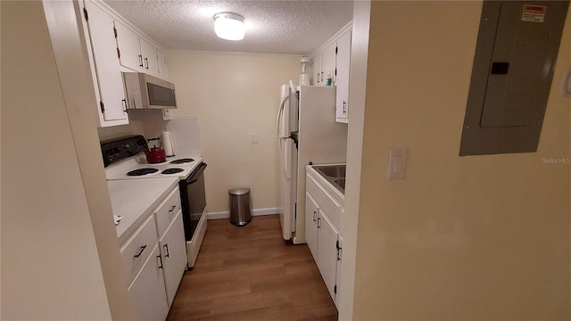 kitchen featuring light hardwood / wood-style flooring, electric panel, a textured ceiling, white appliances, and white cabinets