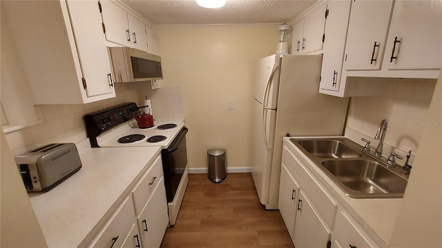 kitchen featuring white cabinetry, electric range, sink, a textured ceiling, and hardwood / wood-style flooring