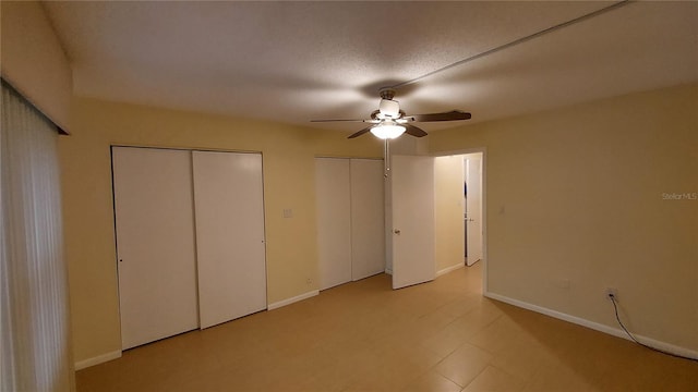 unfurnished bedroom featuring a textured ceiling and ceiling fan