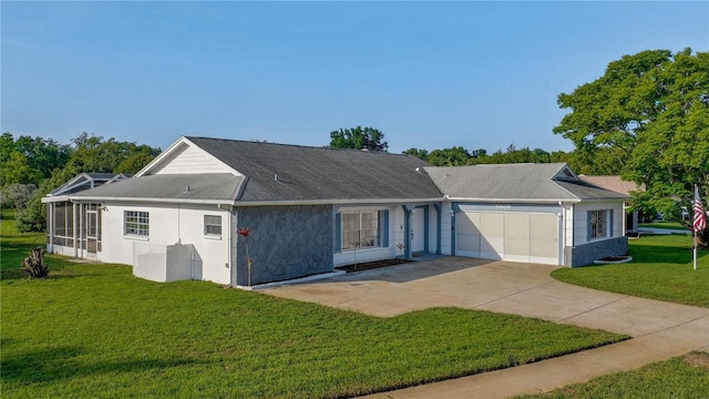 single story home with a sunroom, a front lawn, and a garage