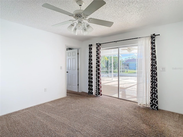 empty room featuring carpet flooring, ceiling fan, and a textured ceiling