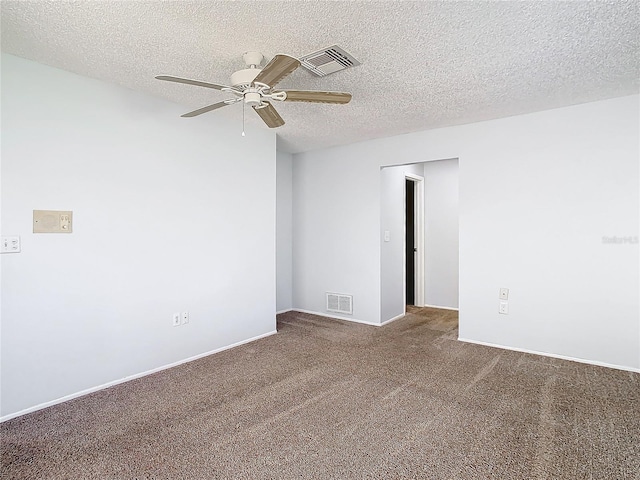 carpeted spare room with ceiling fan and a textured ceiling