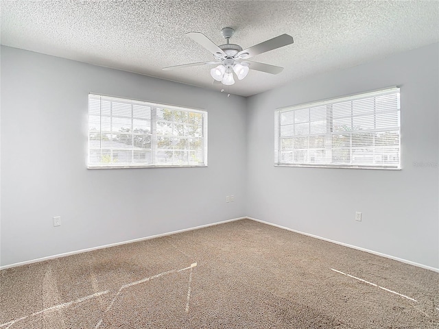 carpeted empty room with a textured ceiling and ceiling fan