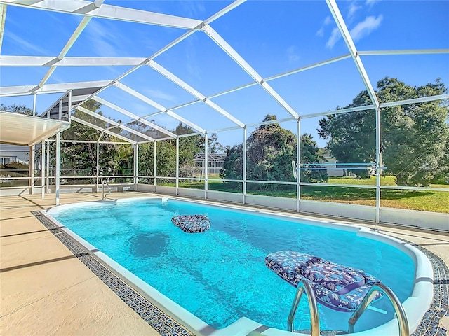 view of swimming pool featuring glass enclosure