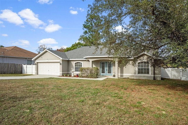 ranch-style house featuring french doors, a garage, and a front lawn