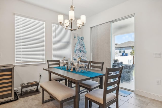 tiled dining area with beverage cooler and an inviting chandelier