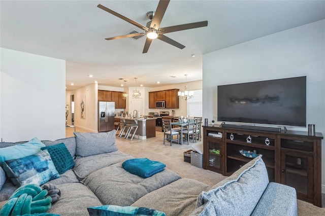 living room featuring ceiling fan with notable chandelier