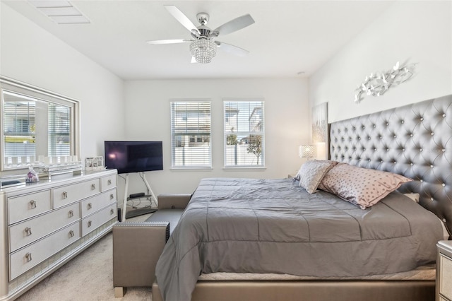 bedroom featuring light carpet and ceiling fan