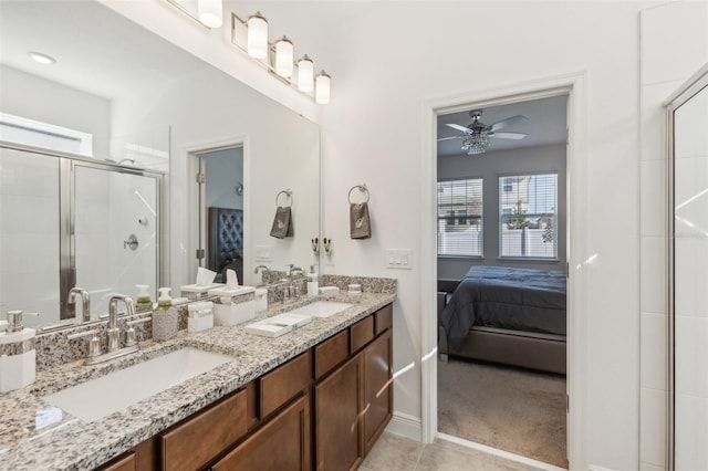 bathroom with tile patterned floors, ceiling fan, a healthy amount of sunlight, and a shower with door