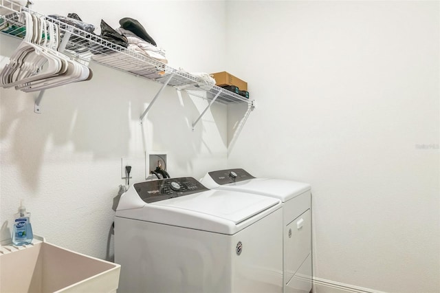 washroom with washer and clothes dryer and sink