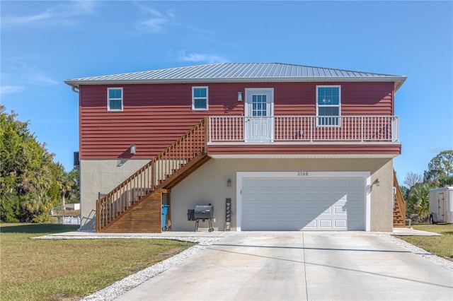 view of front of house with a balcony, a front yard, and a garage