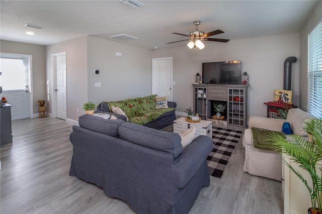 living room featuring light hardwood / wood-style flooring and ceiling fan