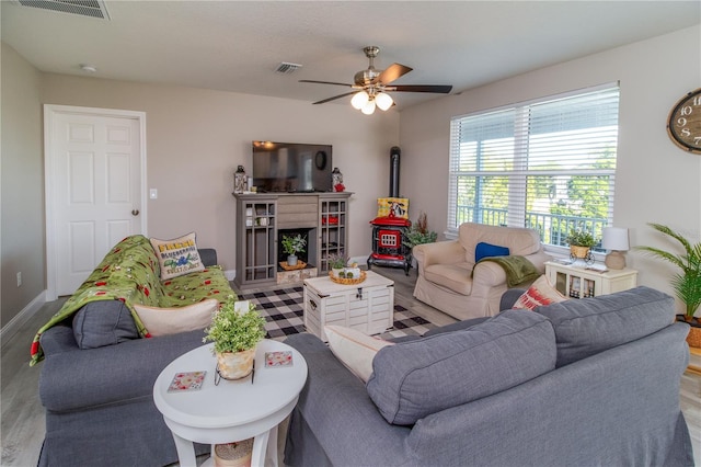 living room featuring ceiling fan and light hardwood / wood-style flooring