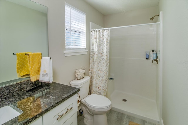 bathroom with wood-type flooring, vanity, toilet, and a shower with curtain