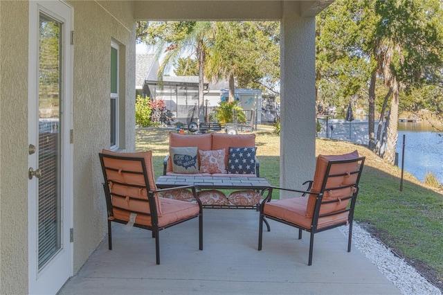 view of patio featuring an outdoor living space and a water view