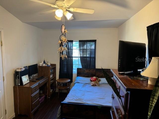 dining room with ceiling fan and dark wood-type flooring