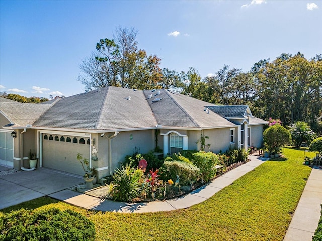 view of front of property with a front lawn and a garage