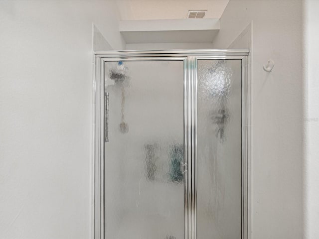 bathroom featuring a shower with shower door