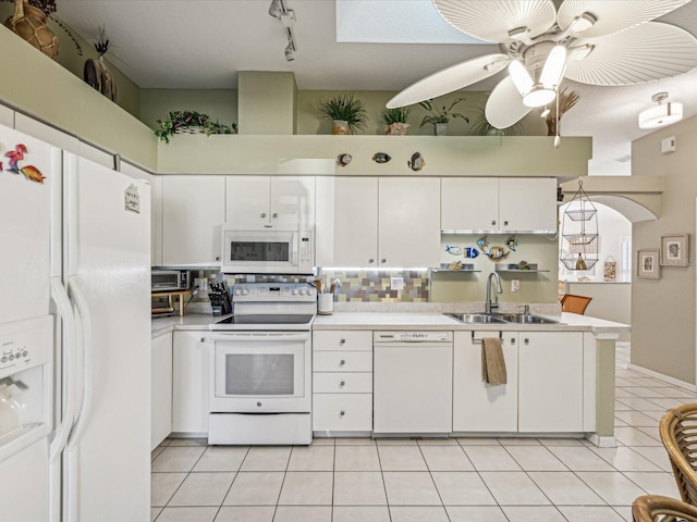 kitchen with sink, white appliances, light tile patterned floors, ceiling fan, and white cabinetry