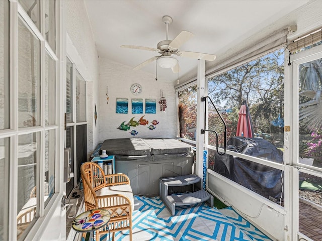 sunroom with ceiling fan and lofted ceiling