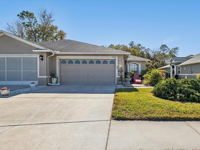 single story home featuring a garage and a front lawn