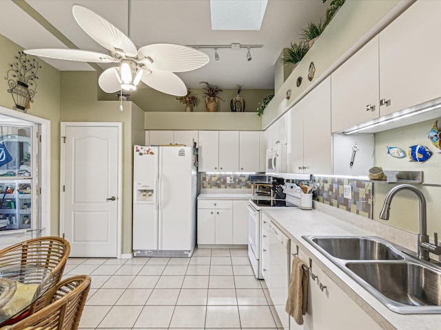 kitchen featuring white cabinetry, sink, white appliances, and light tile patterned floors