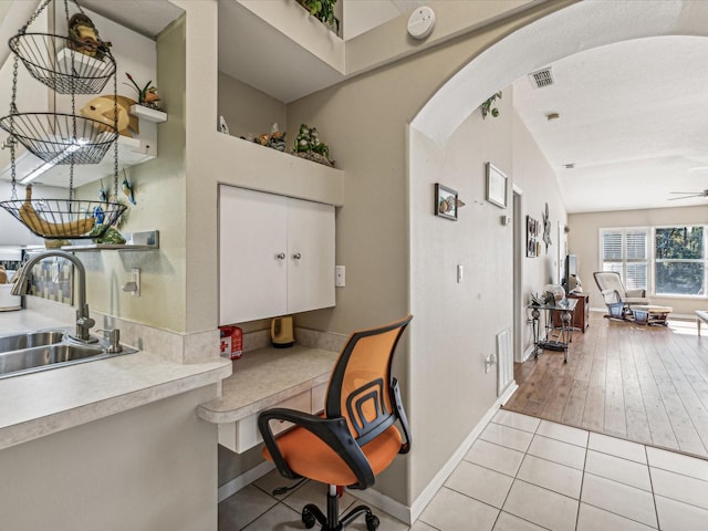 interior space with light tile patterned flooring and sink